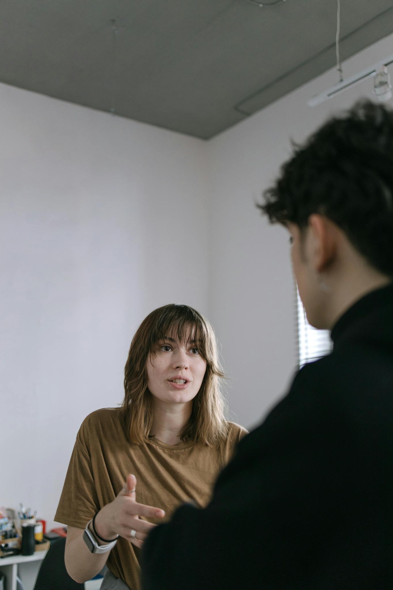 Young professionals in a lively discussion at a modern office setting.